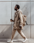 Beige hooded jacket with flap pockets and matching pants, seen in side profile
