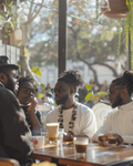 NOIREL NRL161: white shirt with sunglasses and beaded necklace at a café table