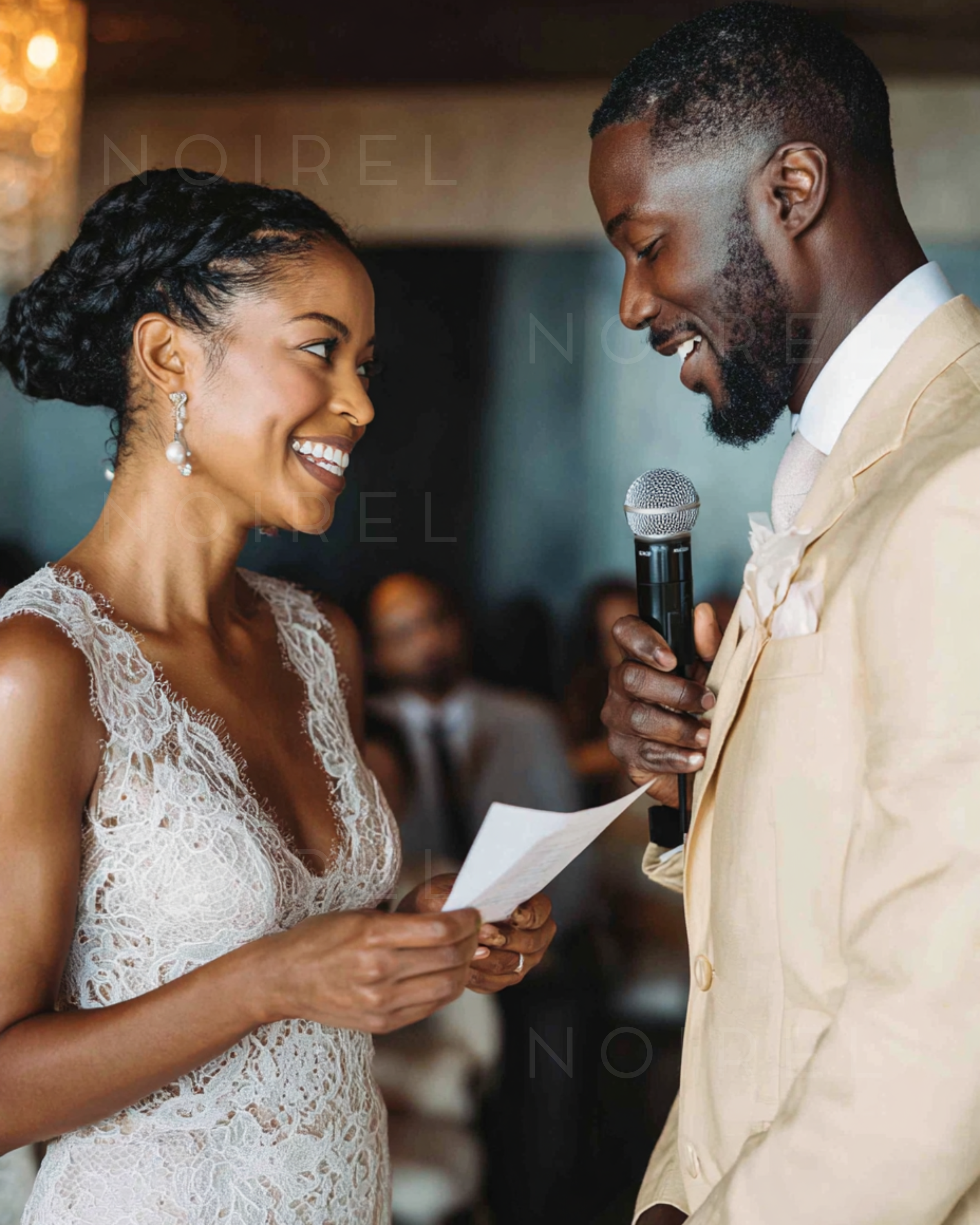 Sleeveless white lace gown, holding notes beside a man in a beige suit with mic