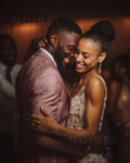 Couple in suit and lace bridal dress, closely hugging