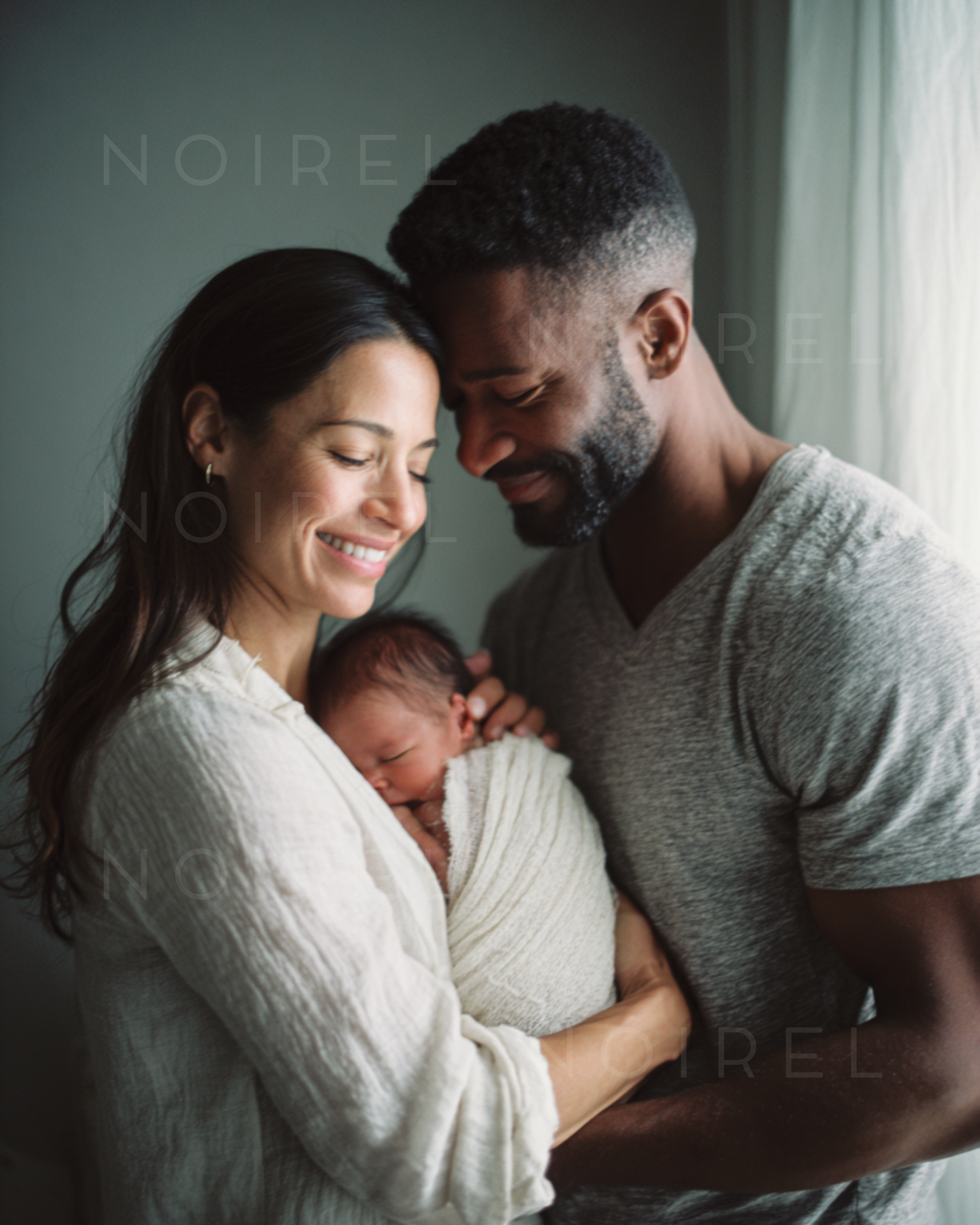NOIREL NRL208: Couple holding a newborn wrapped in cloth, close family moment