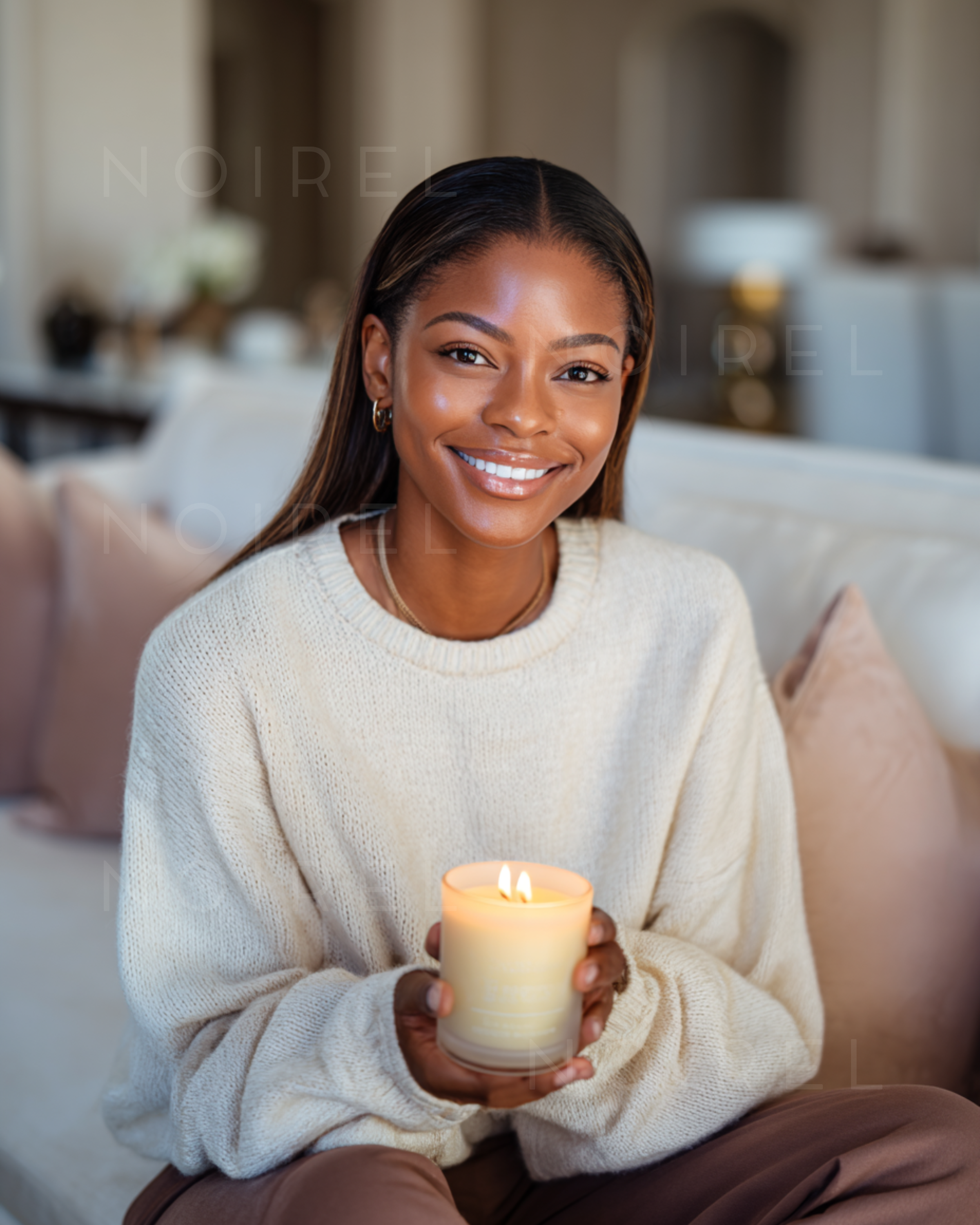 Light cream knit sweater, woman holding a lit candle