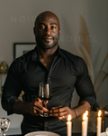 Dark button-up shirt portrait; man holding a small lantern torch