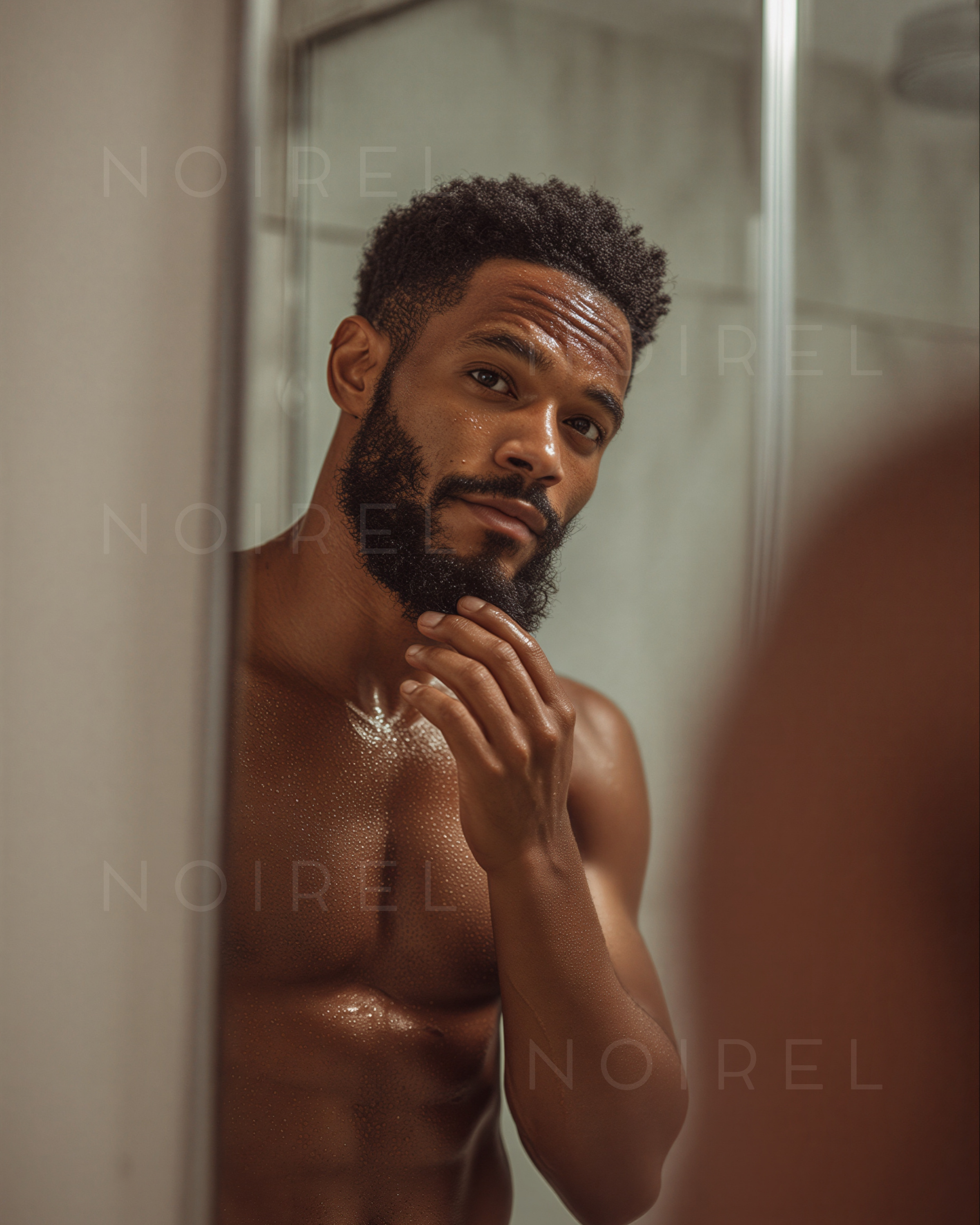 NOIREL NRL029: man with short curly hair and beard, hand on face, wet skin