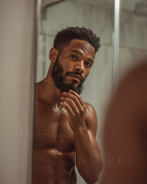 NOIREL NRL029: man with short curly hair and beard, hand on face, wet skin
