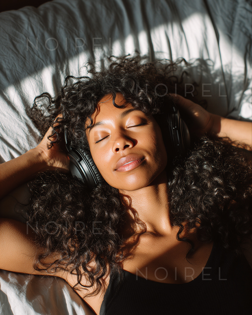 NOIREL NRL039 headphones on head, curly hair, eyes closed