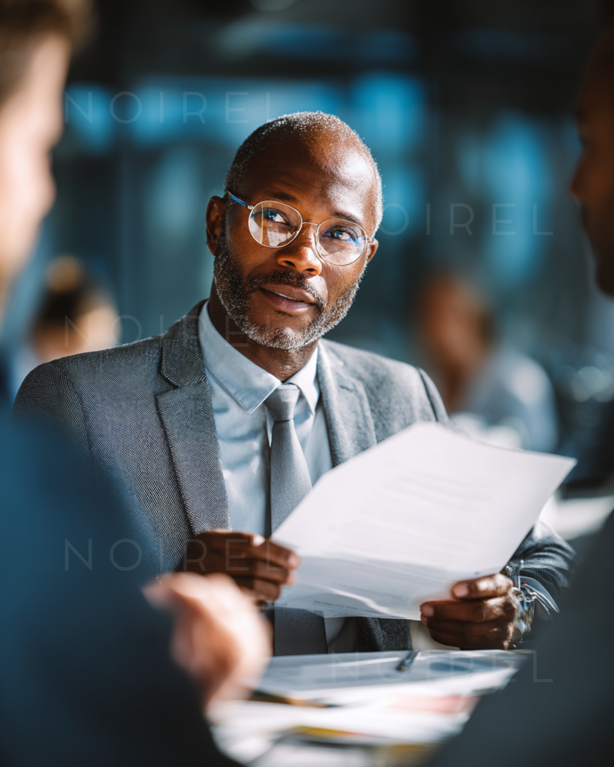 Men’s business suit with tie and glasses, holding documents